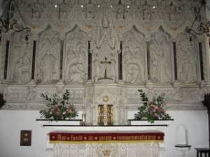 Reredos – A decorative screen or facing on the wall at the back of an altar.